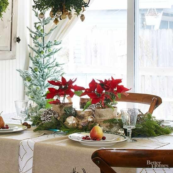 woodland inspired table centerpiece with red poinsettias