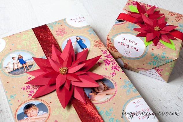 2 presents wrapped & adorned with paper red poinsettia bows