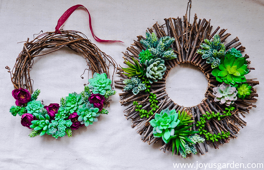 1 vine & 1 twig wreath decorated with faux succulents & faux flowers