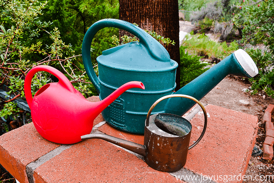 three watering cans