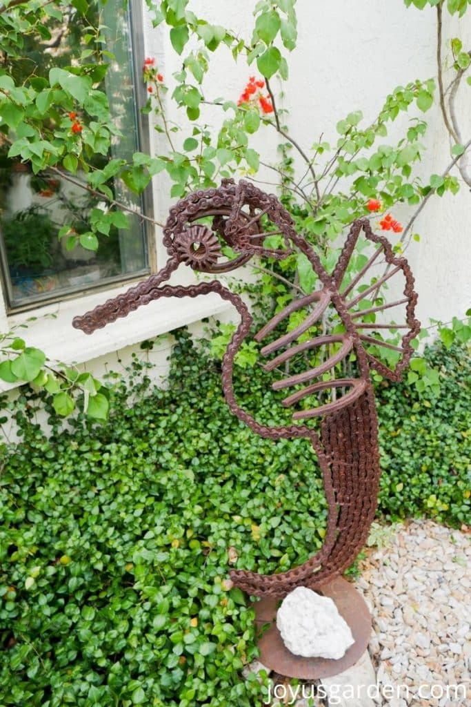 a seahorse made from recycled parts in a garden as art