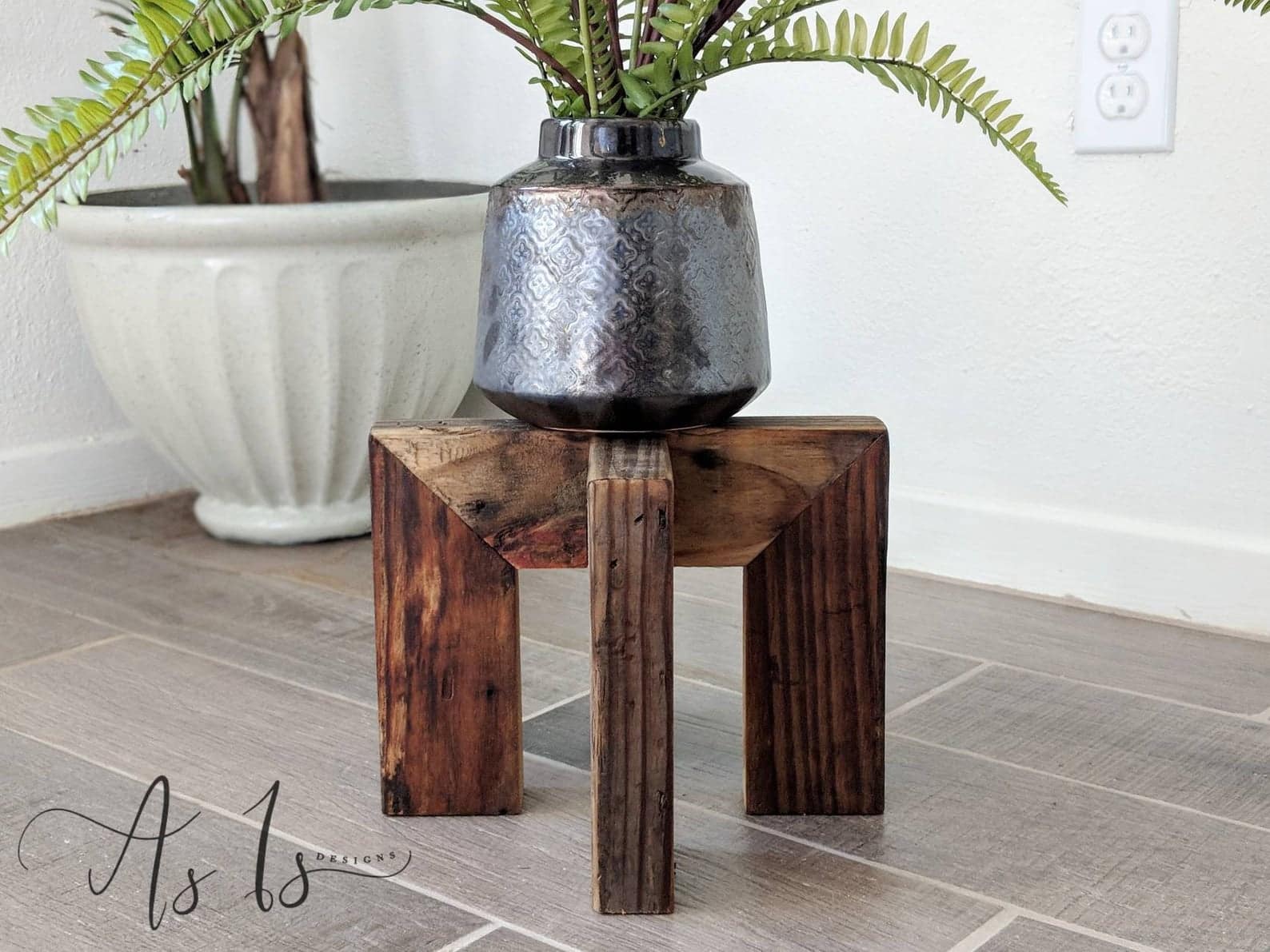 Brown wooden plant stand with plant pot sitting atop. 