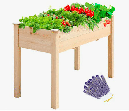 Wooden raised garden bed with plants inside and a pair of gloves in bottom frame of photo for sale at amazon.