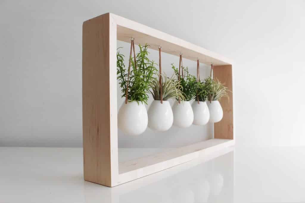 wooden hanging planter frame with five white pots from etsy