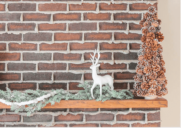 pinecone christmas tree on a fireplace mantle