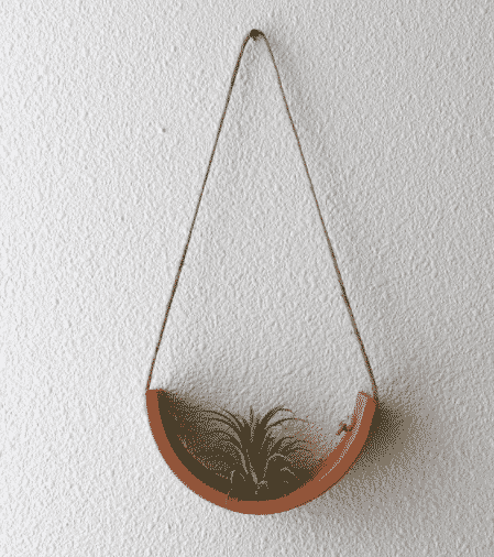 hanging clay air plant cradle with tillandsia sitting on it to buy at etsy