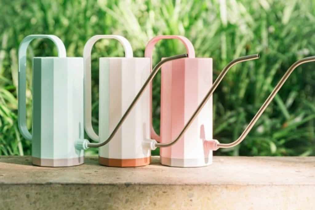 3 small watering cans in mint green, white, & pale pink with long spouts from walmart