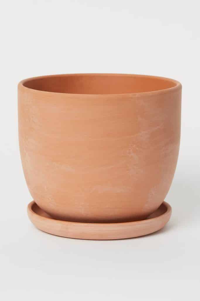 rounded terracotta pot with matching sauces, both have some whitewashing texture