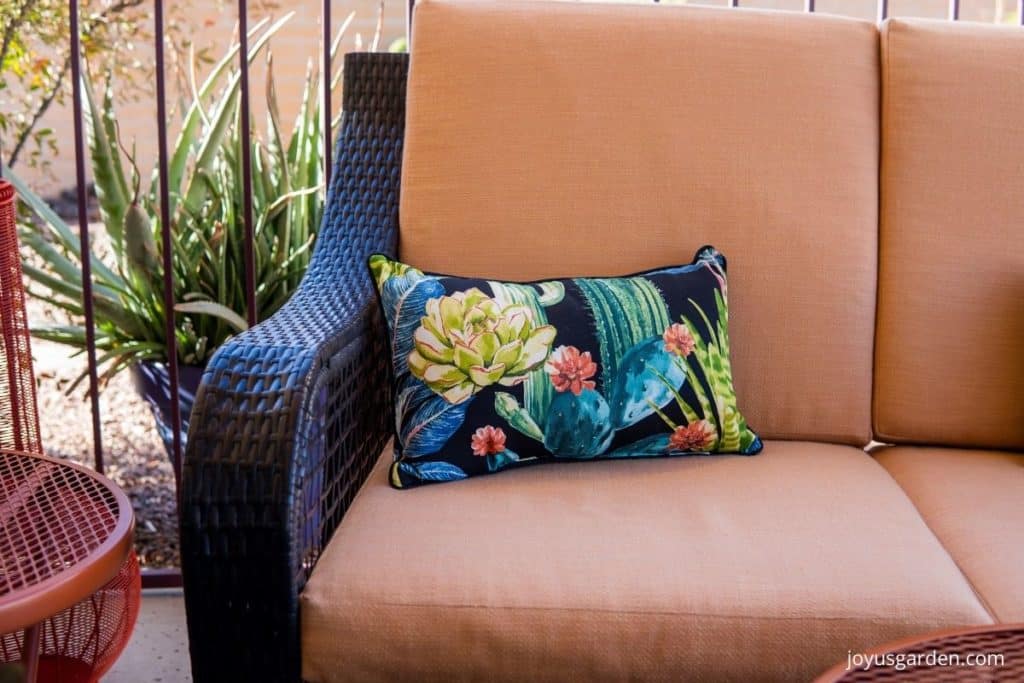 close of of a succulent-themed lumbar patio pillow