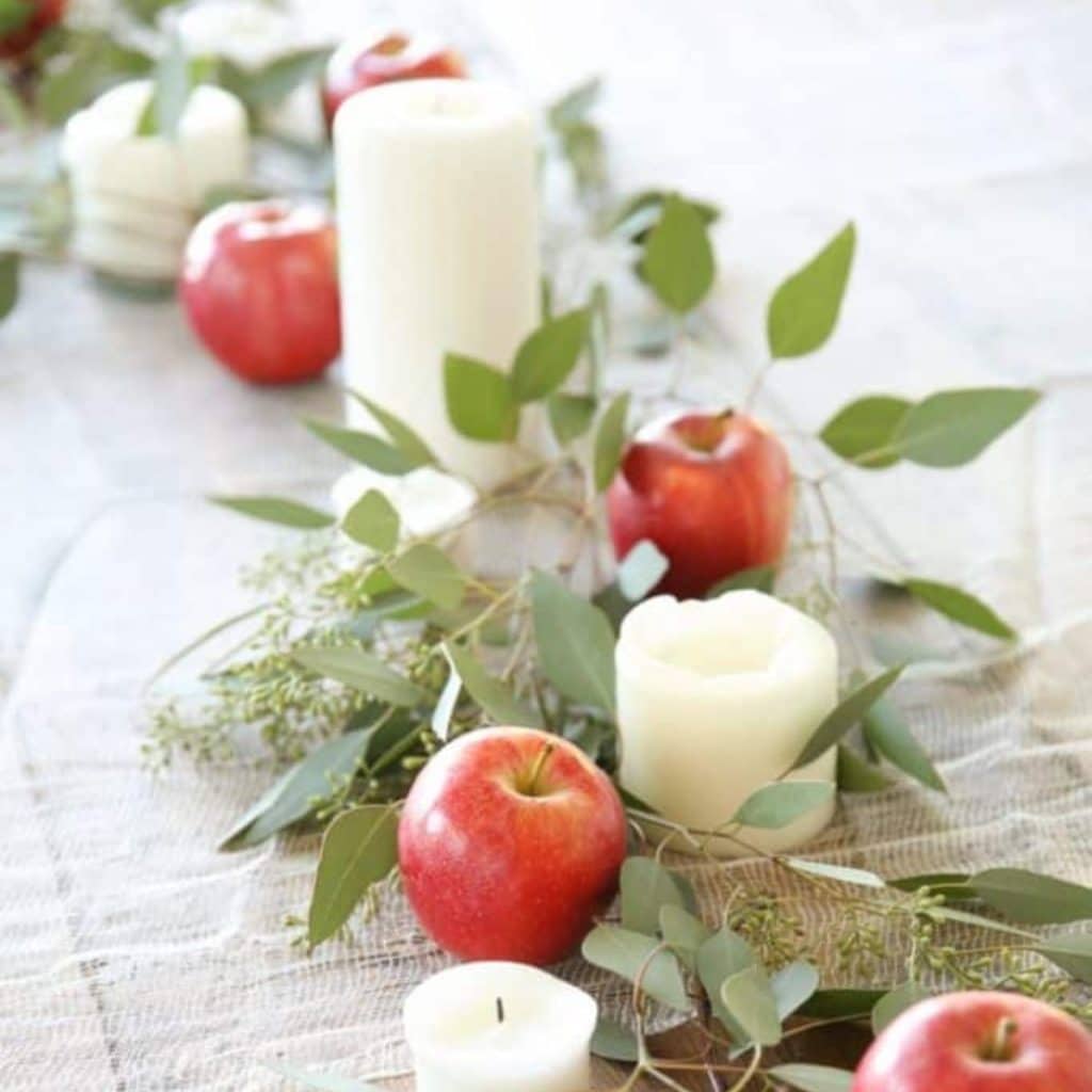 a simple & natural fall tablescape with apples, eucalyptus & candles