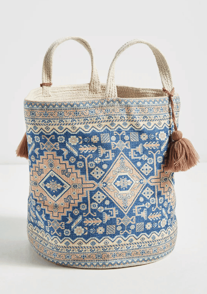 a bohemian style kabi printed basket with a pattern on it, handles, & tassels to buy at anthropologie