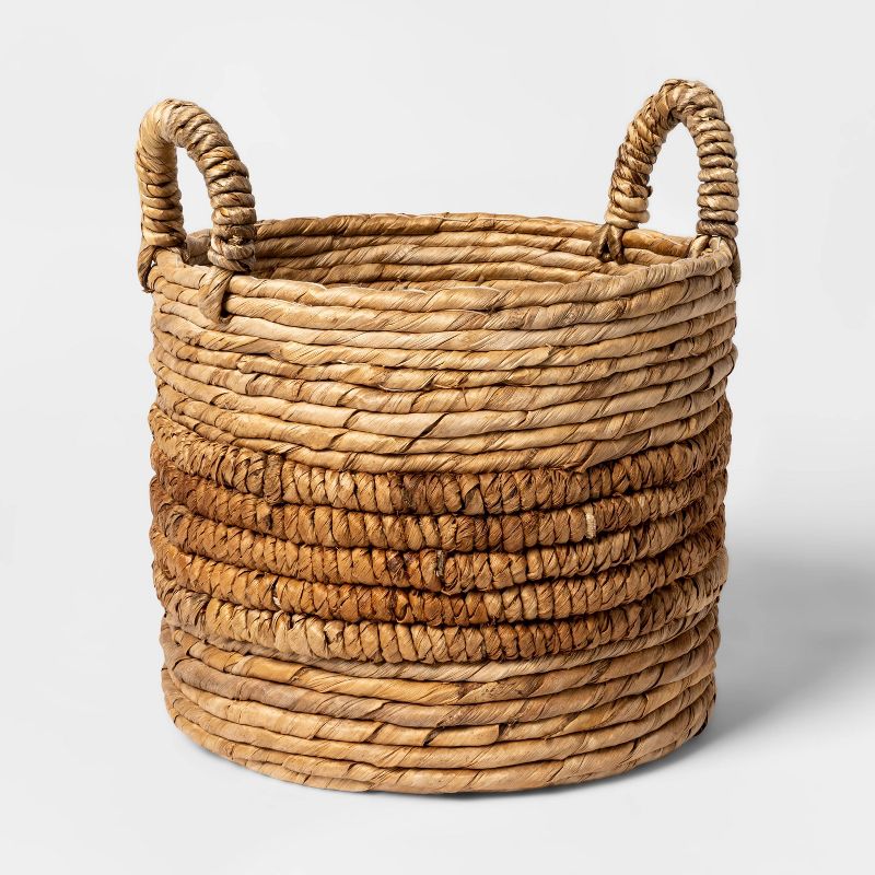 a large natural woven round basket with handles in brown & tan to buy at target