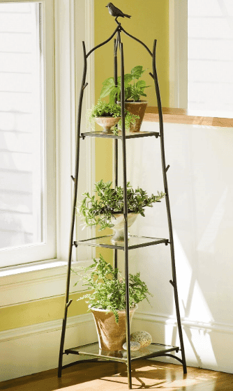 three tier metal plant stand with a variety of plants shown from gardeners