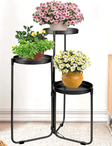 three tier metal plant stand with a variety of plants shown from Amazon