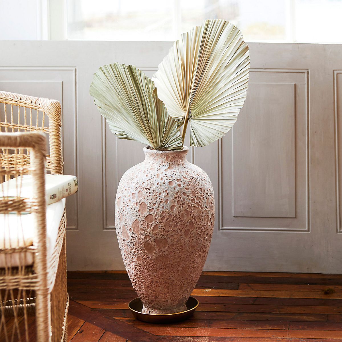 earthenware floor vase show indoors with dried leaves vase has textured markings from terrain