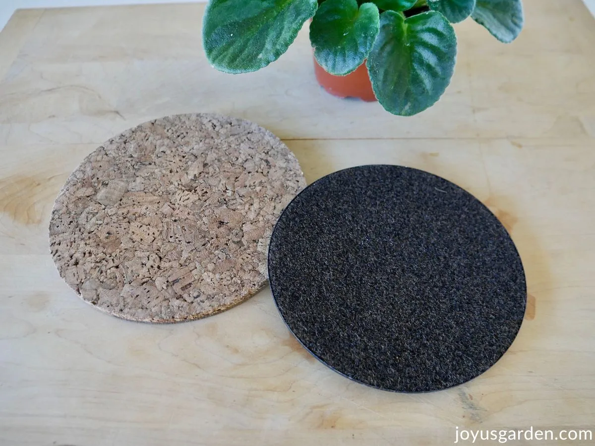 1 black felt mat and 1 cork mat used for houseplant gardening.
